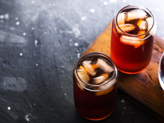 Two glasses of iced coffee . Cold brew in stylish glasses. Dark table copy space