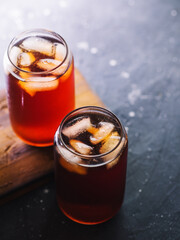 Two glasses of iced coffee . Cold brew in stylish glasses. Dark table copy space