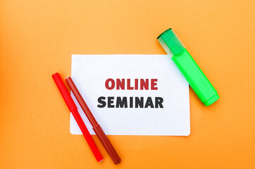 A note with the inscription Online seminar. A type of web conferencing, holding online meetings or presentations over the Internet. Webcasts, and web meetings. Webinar.