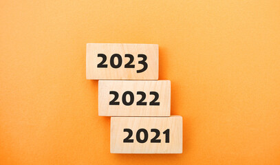 Wooden blocks 2021, 2022, 2023. The concept of the beginning of the new year. New goals. Next decade. Trends and changes in the world. Build plans and planning. Time report