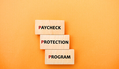 Wooden blocks with words Paycheck Protection Program. Loan that helps businesses keep their workforce employed during the COVID-19 crisis. Business and finance concept