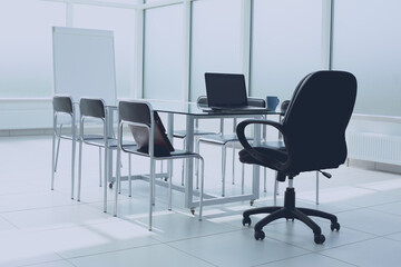 Spacious, bright, modern office space. Glass table. A place to learn at work.