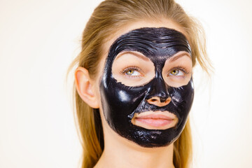 Girl black carbo peel off mask on face