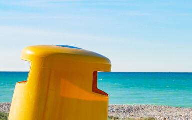 Empty beach with trash can
