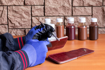 The technological process of applying a protective primer to a cut of a leather product.