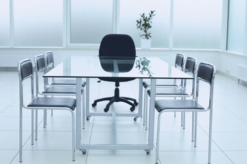 Spacious, bright, modern office space. Glass table. A place to learn at work.