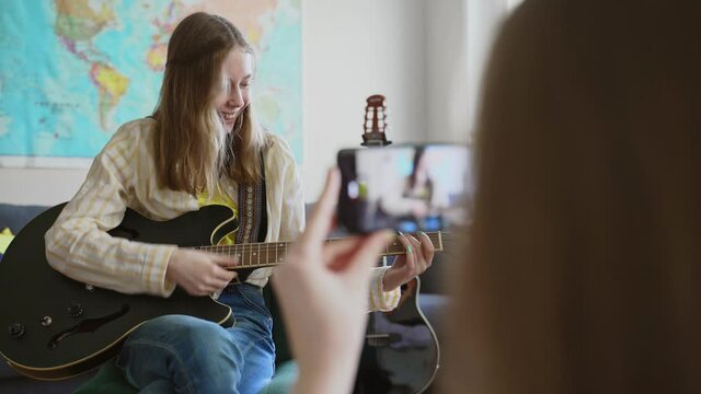 Mom records her daughter on the phone. Video blog concept.