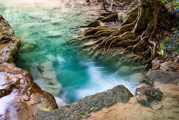 Waterfall and blue emerald water color in Erawan national park. Erawan Waterfall, Beautiful nature rock waterfall steps in tropical rainforest at Kanchanaburi province, Thailand