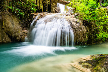 Waterfall and blue emerald water color in Erawan national park. Erawan Waterfall, Beautiful nature rock waterfall steps in tropical rainforest at Kanchanaburi province, Thailand
