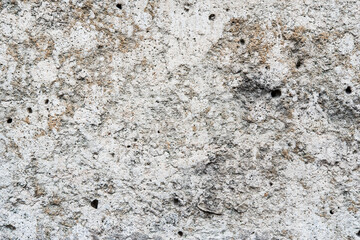 Old stone wall with holes. Close up view