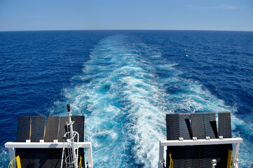Water trail foaming behind a ferry boat in Mediterranean sea