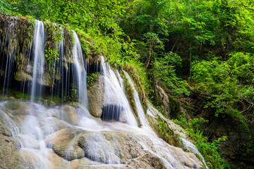 Waterfall and blue emerald water color in Erawan national park. Erawan Waterfall, Beautiful nature rock waterfall steps in tropical rainforest at Kanchanaburi province, Thailand