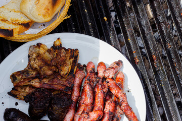 Different types of meat cooked on barbecue and toast