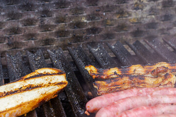 Different types of meat cooked on barbecue and toast
