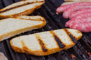 Different types of meat cooked on barbecue and toast