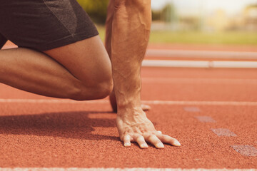 a young athlete doing sports on an outdoor alley track