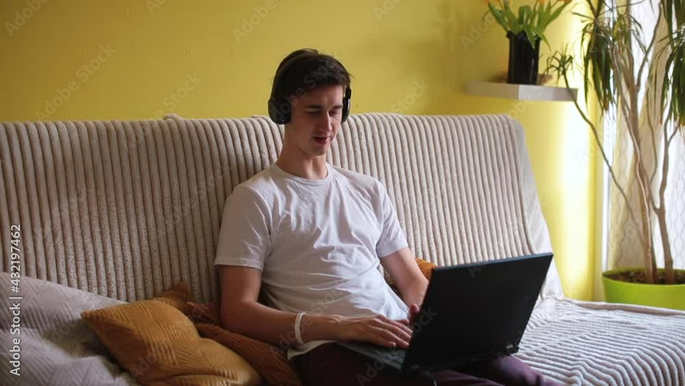 Poster a man makes a video conversation using a laptop in the room. he transmits the message using the inte