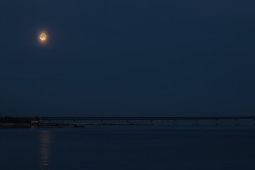 Full moon over Scanian ( sk&aring;ne ) landscape in the morning in the spring