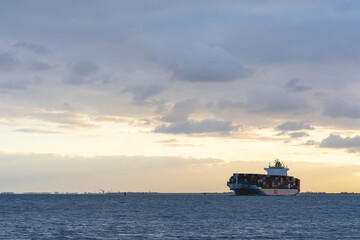 sunset behind a Cargo ship