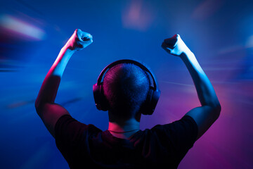 gamer playing game by wearing headphone with computer, gaming and esports streaming concept