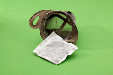 Tea bag inside metal strainer