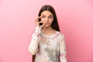 Little girl over isolated pink background showing a sign of silence gesture