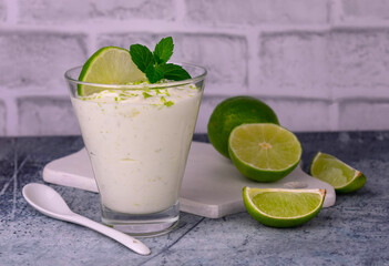 Yogurt with lime and mint in a glass. Refreshing dessert.