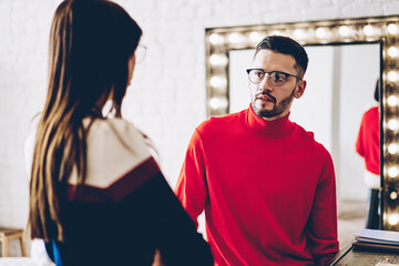 Caucasian male and female colleagues discussing ideas during collaborative meeting in home apartment, young man in optical spectacles for provide eyes correction talking with girlfriend on weekend