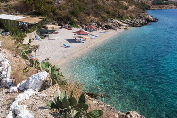 Small picturesque beach and clear turquoise water in Porto Palermo, Albania. View from above....