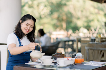 Women enjoyed holidays by resting and eating breakfast on the table.