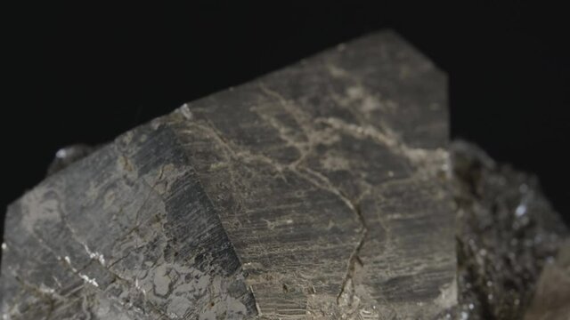 Pyrite dodecahedral crystals on hematite (also known as fool's gold or iron pyrite), isolated on a black background