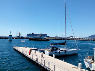 Sunny view of the port.  Cruise liner in the harbor. Beautiful panoramic landscape on a sunny day. A wonderful trip to the Cote d'Azur in France. Scenic harbour view of the city of the sea country. 