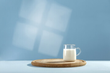 Fresh milk and blue background with shadow 