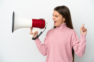 Little girl over isolated white background shouting through a megaphone to announce something in...