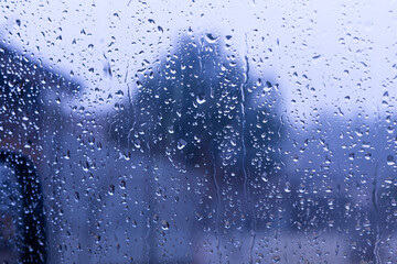 Water drops on tinted car glass after rain