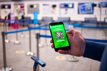 health Vaccine Passport for Coronavirus or Covid-19. Traveller Using Mobile Phone with Vaccination in Immune Status to Certificated International Traveling in Airport