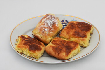 Breakfast. branzoici on a porcelain platter ,Croissants, donuts. romanian homemade  crullers 