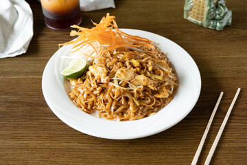 Chicken pad thai served in a Thai restaurant. Delicious and authentic pad thai. 
