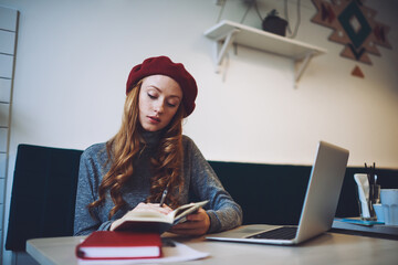 Woman flipping through pages of notebook