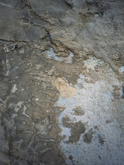 Weathered and cracked concrete wall maintained through time with blue lime and different mortar mixes. Peeling plaster from cement structure surface. Construction element, abstract texture background