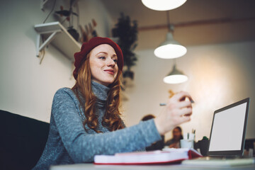 Happy woman at table working in cafe