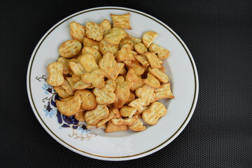 Mix of salty snacks (crackers and pretzels,bagels) in a bowl