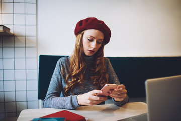 Woman reading messages on mobile phone