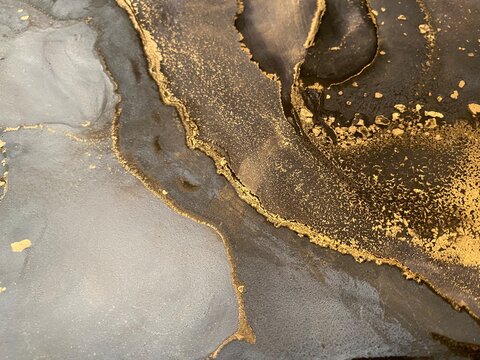 Abstract gold art with black and grey &mdash; fluid background with beautiful smudges and stains made with alcohol ink and golden pigment. Alcohol Ink texture resembles khokhloma, watercolor or aquarel