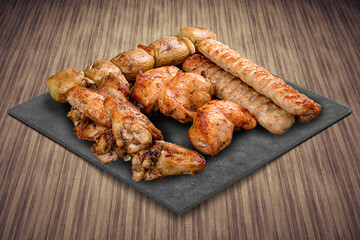 A selection of various barbecued gourmet meats on a black board with a rustic timber background. Assorted meat