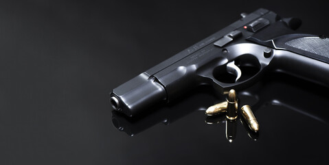 9 mm pistol with luger ammunitions on a black mirror base.