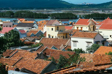 Fototapeta na wymiar A view of a small country town with traditional houses with orange roofs in Vietnam