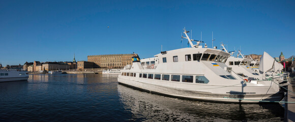 Morning view over a pier with commuting boats lined up before leaving for the Stockholm archipelago