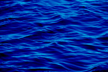 Texture of glitter water and soft waves. sparkling in water - background. sea water with sun glare...