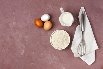 Dough ingredients, milk, eggs, flour and whisk, on the table, top view, background, no people, horizontal,
